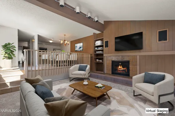 a living room with furniture a flat screen tv and a fireplace