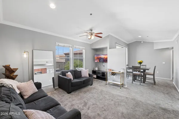 a living room with furniture and a large window