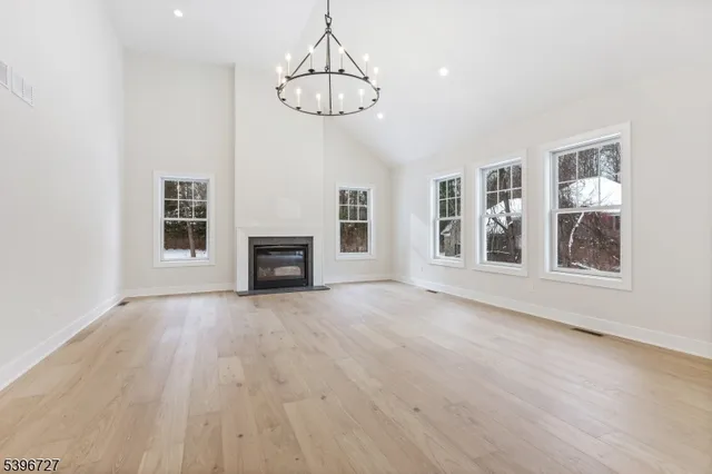 a big room with chandelier and windows