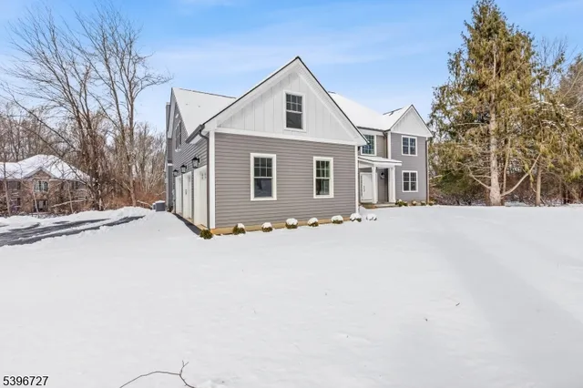 a front view of house with yard and trees around