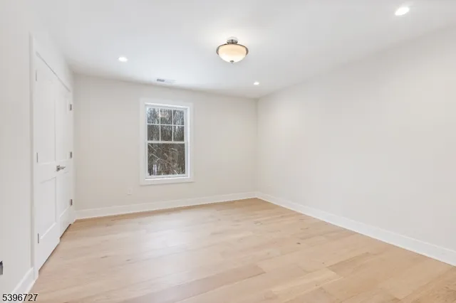 an empty room with windows and closet