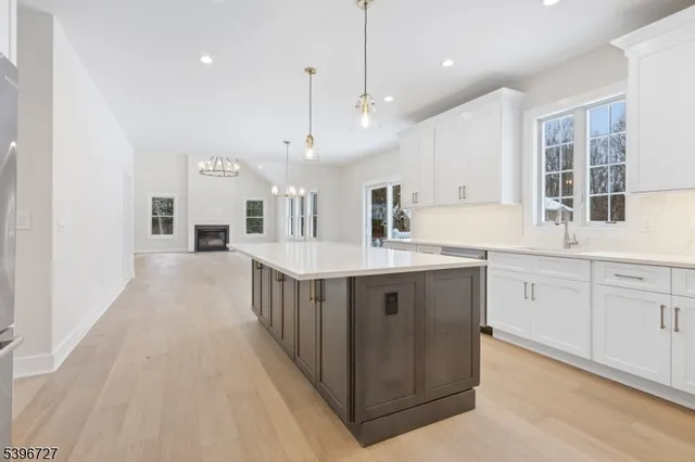 a kitchen with cabinets appliances and a window