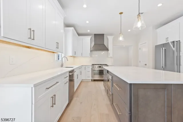 a kitchen with a sink stove and refrigerator