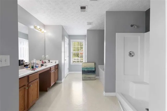 a large bathroom with a glass door shower a sink and a bathtub