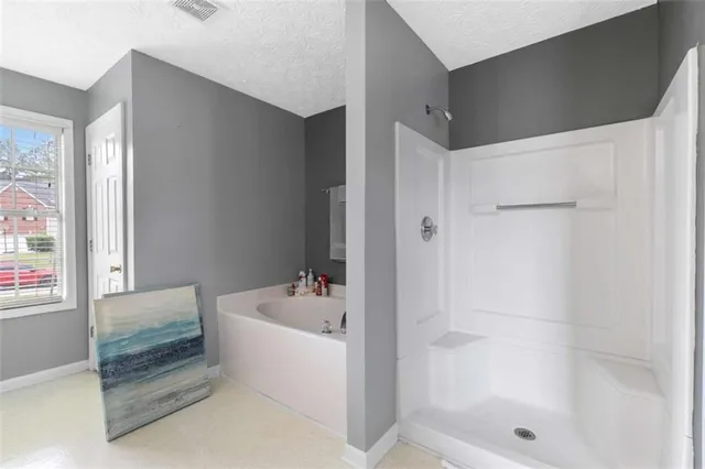 a bathroom with a bathtub and a shower