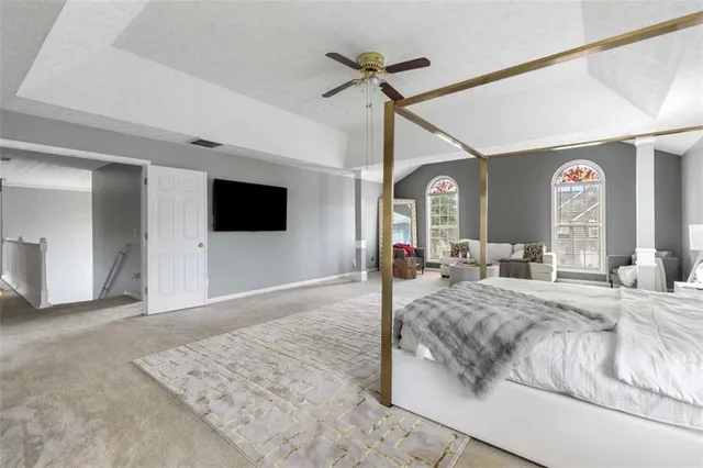 a bedroom with a bed window and a flat screen tv