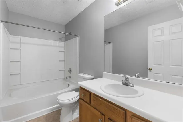 a bathroom with a sink a toilet and a bathtub