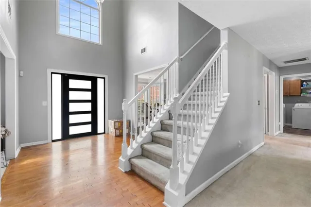 a view of entryway and hall with wooden floor