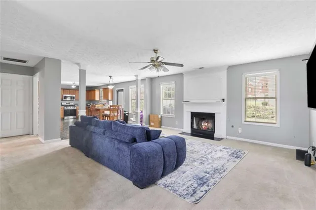 a living room with furniture and a fireplace