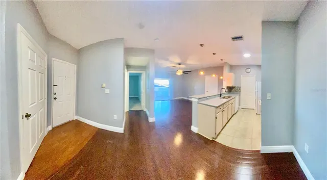 a view of a kitchen cabinets and wooden floor