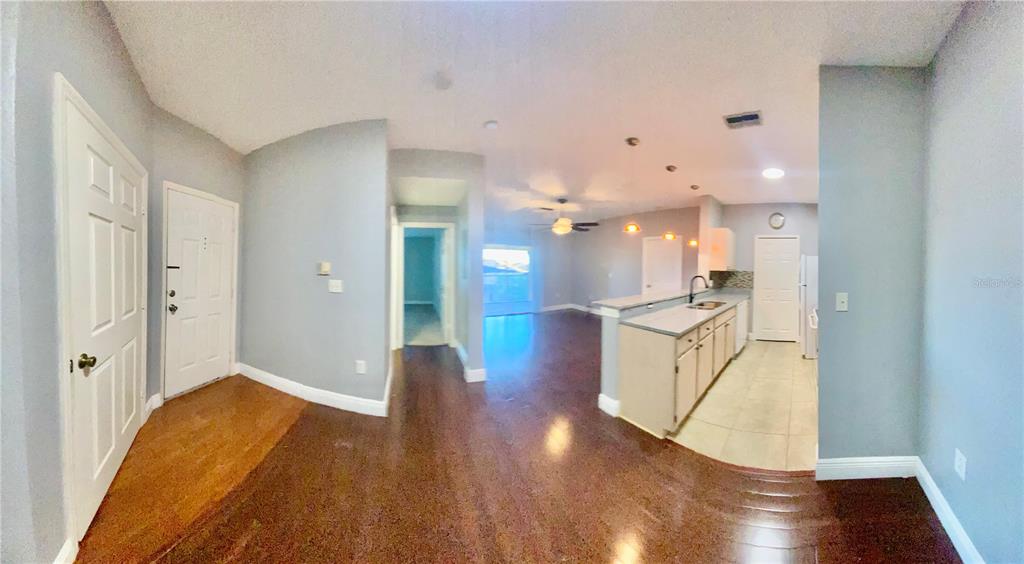 5451 Vineland Road, Unit 2309 Orlando, FL 32811 - Photo 13 of 38 a view of kitchen and hall with wooden floor