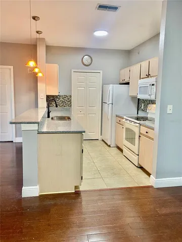 an empty room with a ceiling fan and window