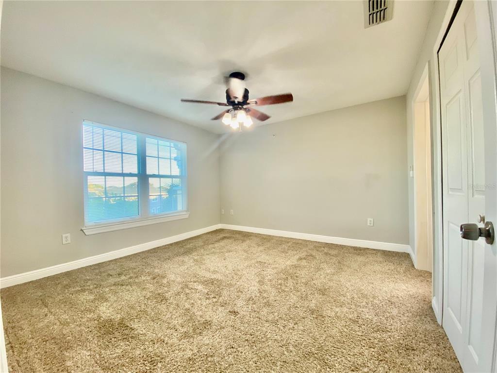 5451 Vineland Road, Unit 2309 Orlando, FL 32811 - Photo 17 of 38 an empty room with a ceiling fan and window