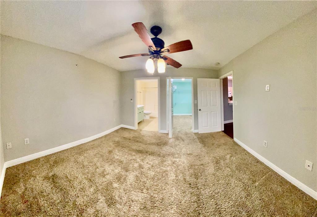 5451 Vineland Road, Unit 2309 Orlando, FL 32811 - Photo 20 of 38 a view of a room with a ceiling fan and a window