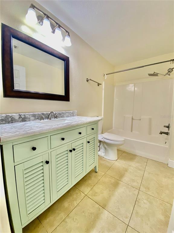 5451 Vineland Road, Unit 2309 Orlando, FL 32811 - Photo 23 of 38 a bathroom with a toilet sink and mirror