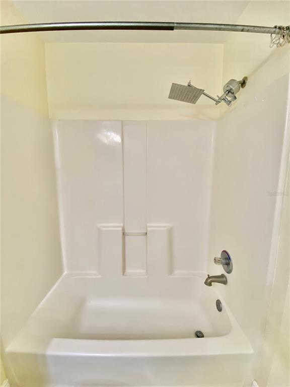 5451 Vineland Road, Unit 2309 Orlando, FL 32811 - Photo 24 of 38 a bathroom with a shower and a shower
