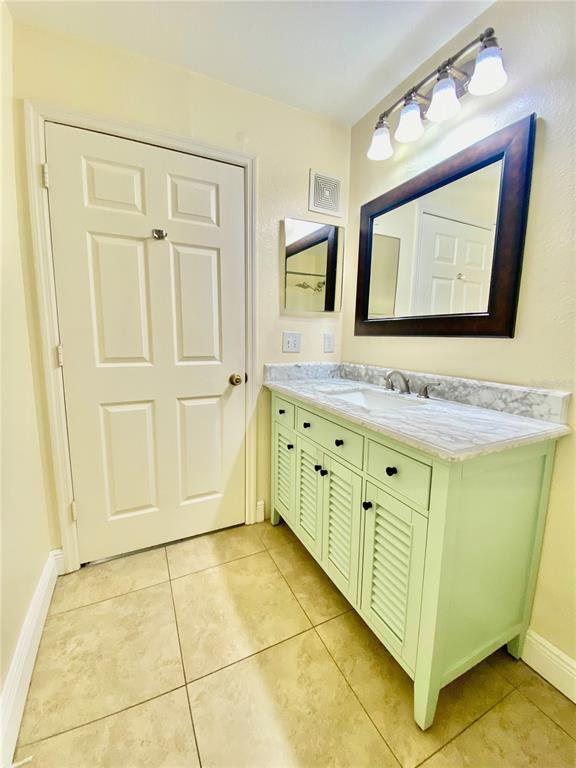 5451 Vineland Road, Unit 2309 Orlando, FL 32811 - Photo 25 of 38 a bathroom with a mirror sink and vanity