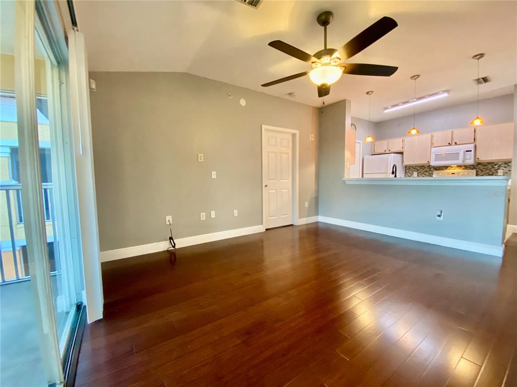 5451 Vineland Road, Unit 2309 Orlando, FL 32811 - Photo 27 of 38 wooden floor in an empty room with a window