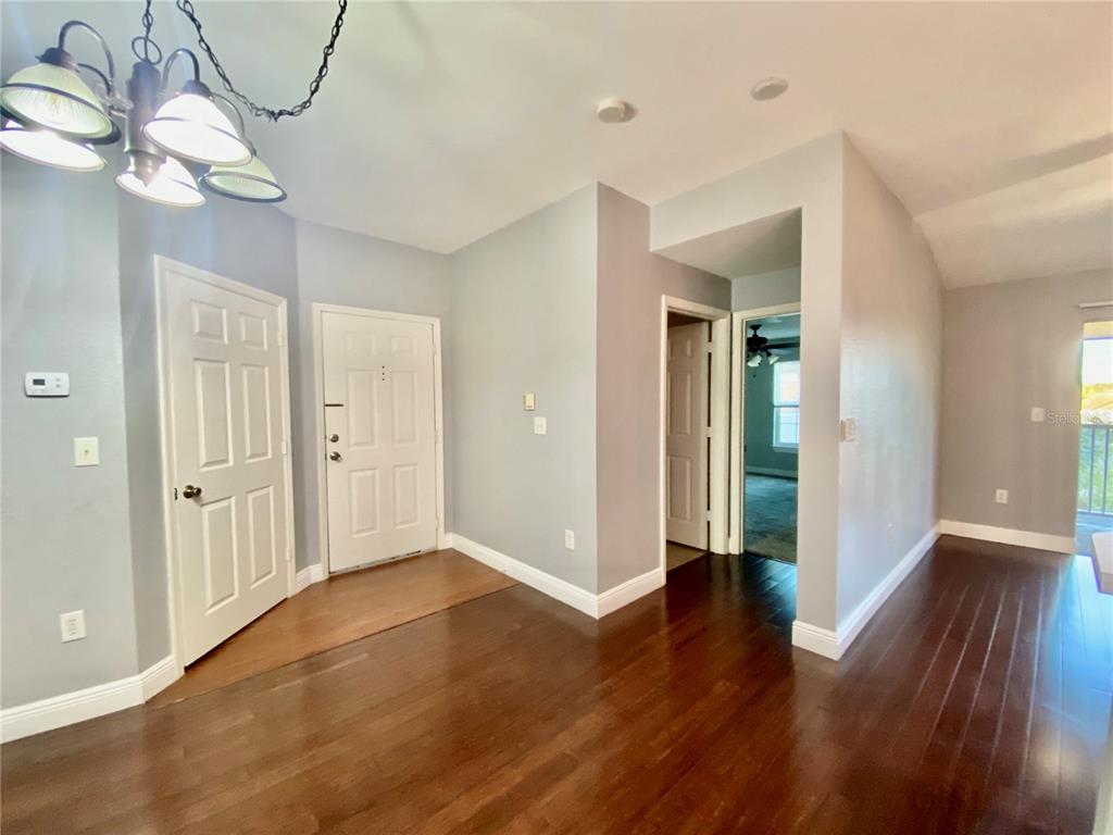 5451 Vineland Road, Unit 2309 Orlando, FL 32811 - Photo 28 of 38 a view of a hallway with wooden floor