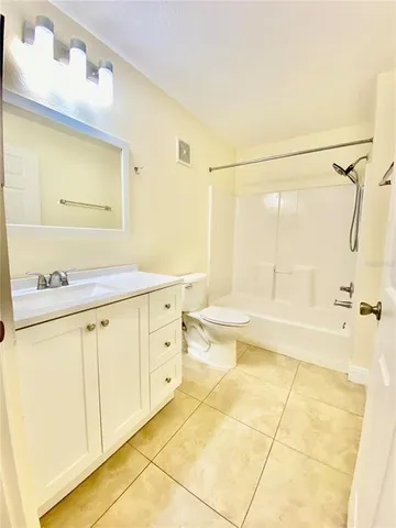 a bathroom with a shower and a glass door