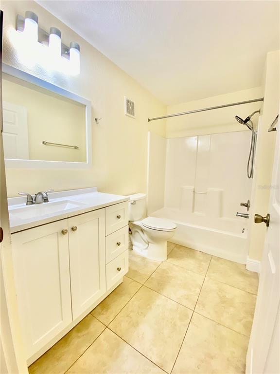 5451 Vineland Road, Unit 2309 Orlando, FL 32811 - Photo 31 of 38 a spacious bathroom with a granite countertop sink mirror and bathtub