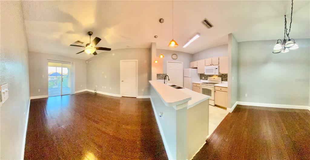 5451 Vineland Road, Unit 2309 Orlando, FL 32811 - Photo 34 of 38 a view of a kitchen with furniture and wooden floor