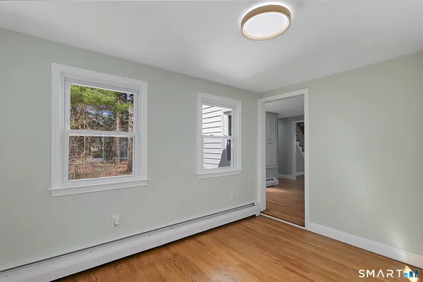 a living room with furniture a rug and a window