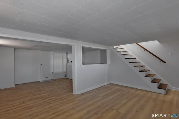 an empty room with wooden floor and white walls