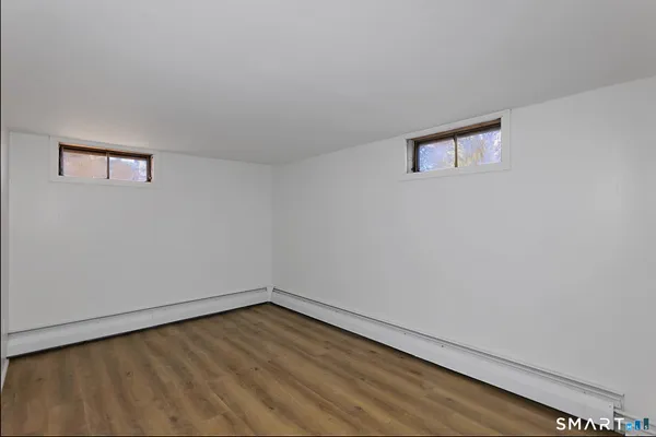 a view of a house with backyard and a tree