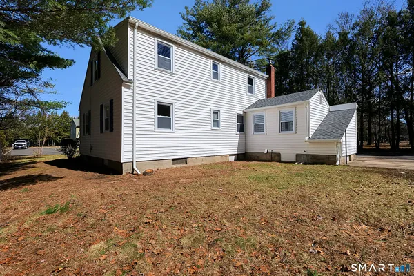 a view of a white house with a yard and garage