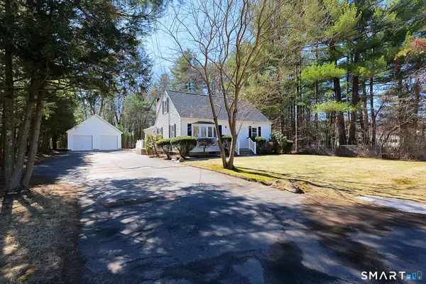 a living room with furniture a flat screen tv and a window