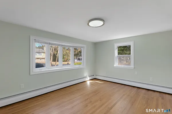 a view of entryway and hall with wooden floor