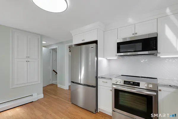 a living room with furniture a rug and a window