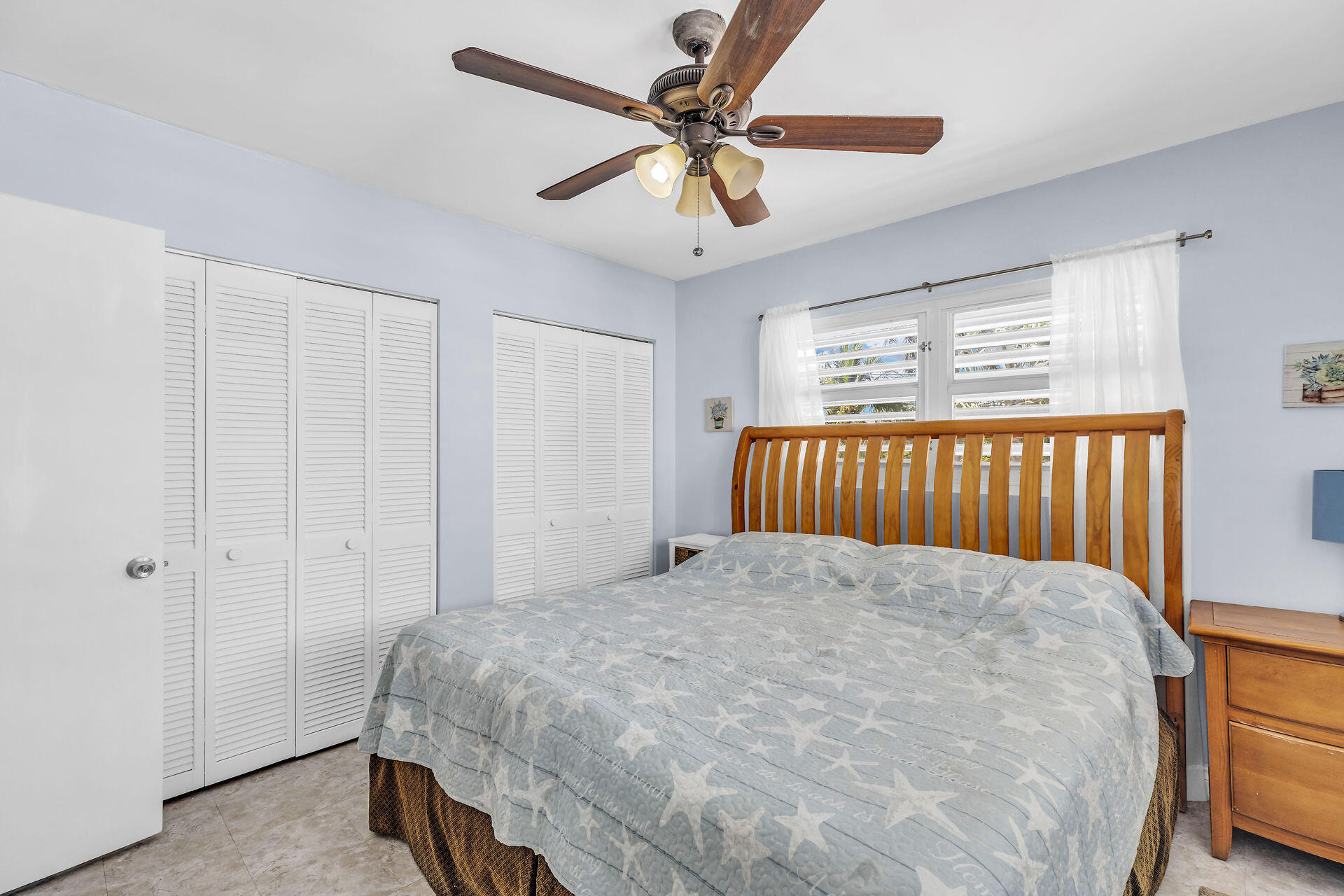 106 Channel Drive, Unit B Marathon, FL 33050 - Photo 20 of 33 a bedroom with a bed and a chandelier