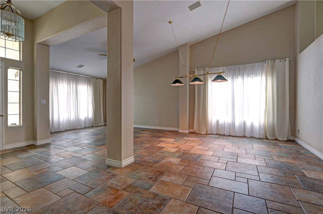 2108 Crestpoint Way Las Vegas, NV 89134 - Photo 5 of 27 Natural light illuminates the textured tile flooring and vaulted ceilings of this spacious room.