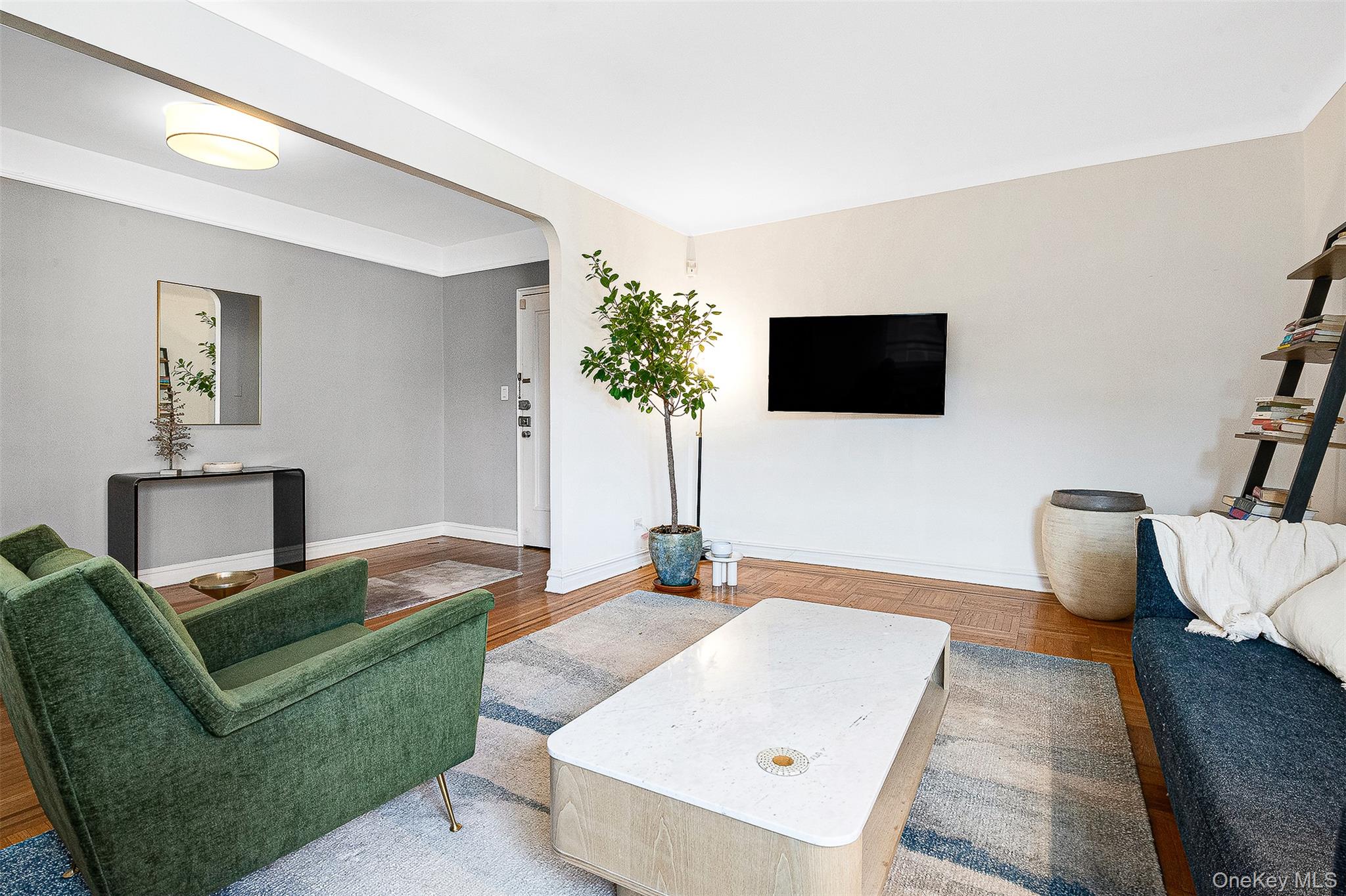 99-45 67th Road, Unit 514 Queens, NY 11375 - Photo 11 of 22 a living room with furniture and a flat screen tv