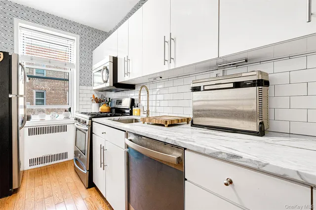 a kitchen with stainless steel appliances granite countertop a sink and a stove