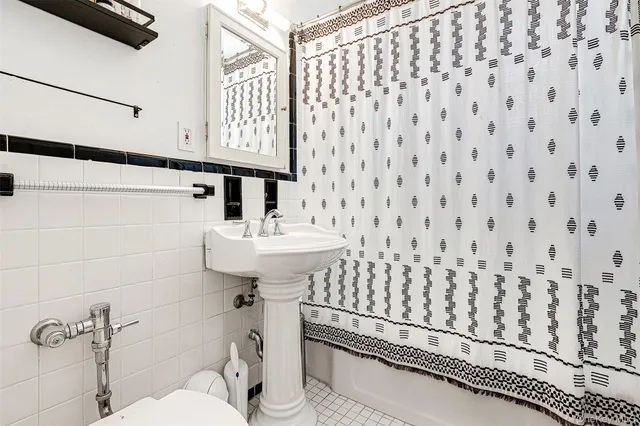 a bathroom with a sink toilet and mirror