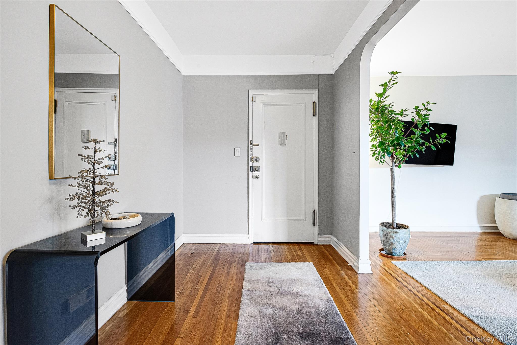 99-45 67th Road, Unit 514 Queens, NY 11375 - Photo 4 of 22 a living room with furniture and a flat screen tv