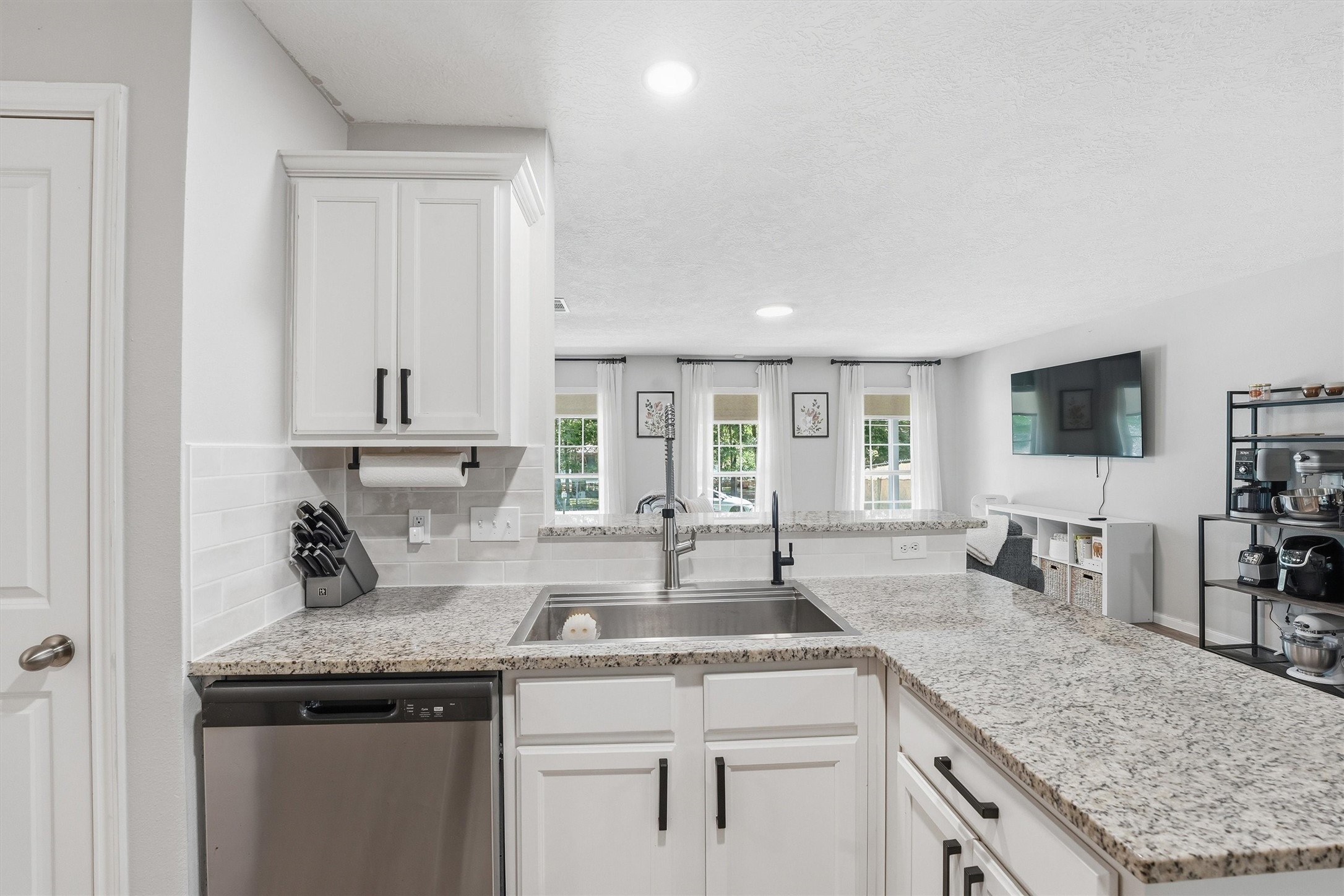 15011 Crockett Road Willis, TX 77378 - Photo 7 of 24 Kitchen with upgraded sink, RO system, and open view to living area.