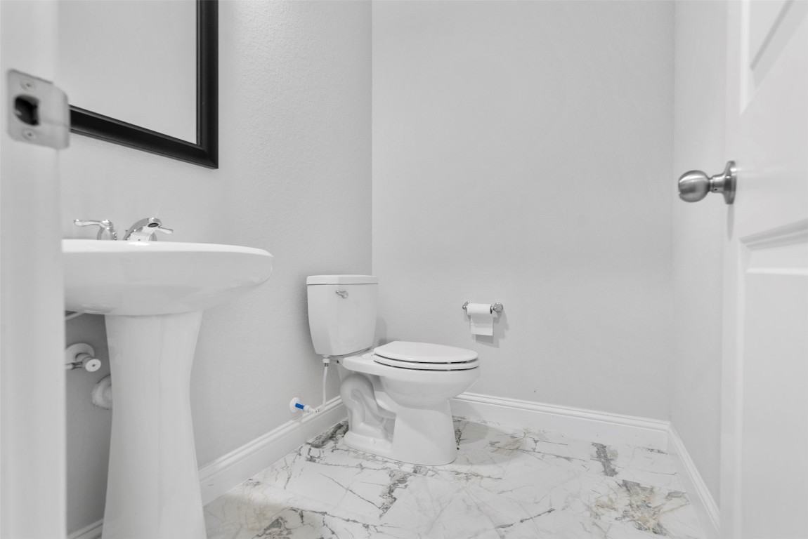 148 Gray Pne Grove Conroe, TX 77318 - Photo 12 of 46 a bathroom with a toilet sink and mirror