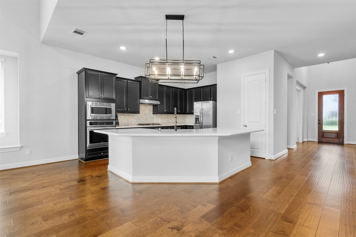 148 Gray Pne Grove Conroe, TX 77318 - Photo 15 of 46 a view of kitchen with stainless steel appliances granite countertop stove top oven and cabinets