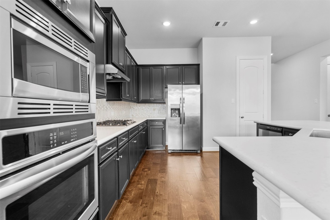 148 Gray Pne Grove Conroe, TX 77318 - Photo 17 of 46 a kitchen with stainless steel appliances a sink dishwasher a refrigerator and cabinets
