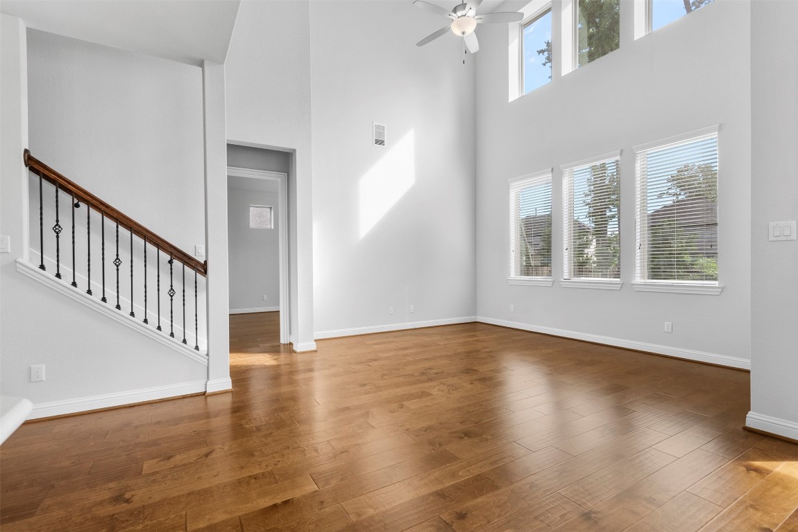 148 Gray Pne Grove Conroe, TX 77318 - Photo 18 of 46 a view of an empty room with wooden floor and a window