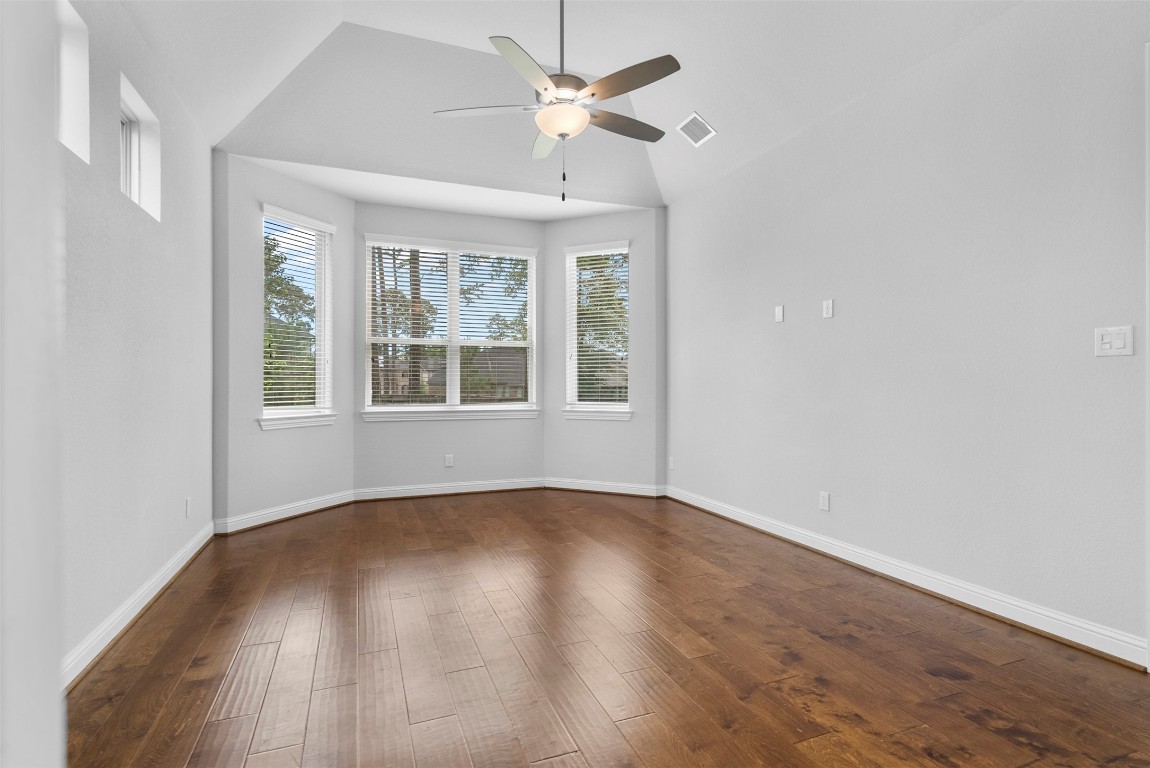 148 Gray Pne Grove Conroe, TX 77318 - Photo 22 of 46 a view of an empty room with wooden floor and a window