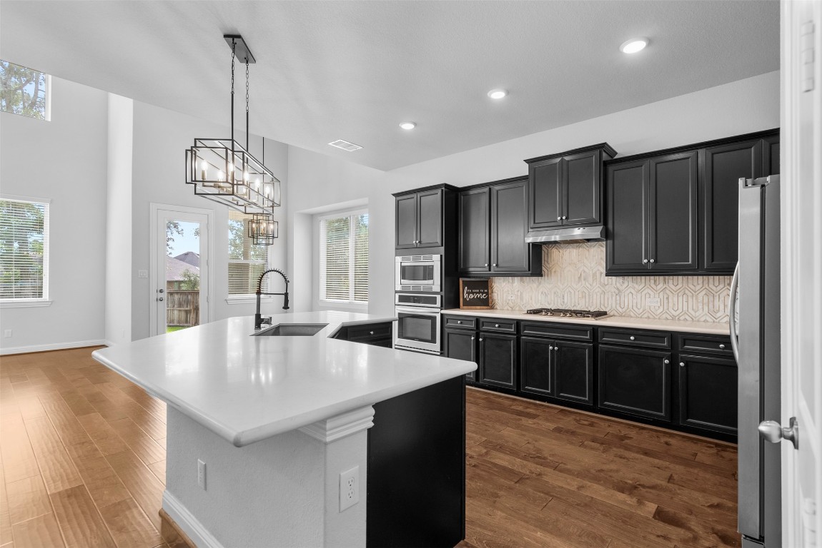 148 Gray Pne Grove Conroe, TX 77318 - Photo 26 of 46 a large kitchen with granite countertop lots of counter top space