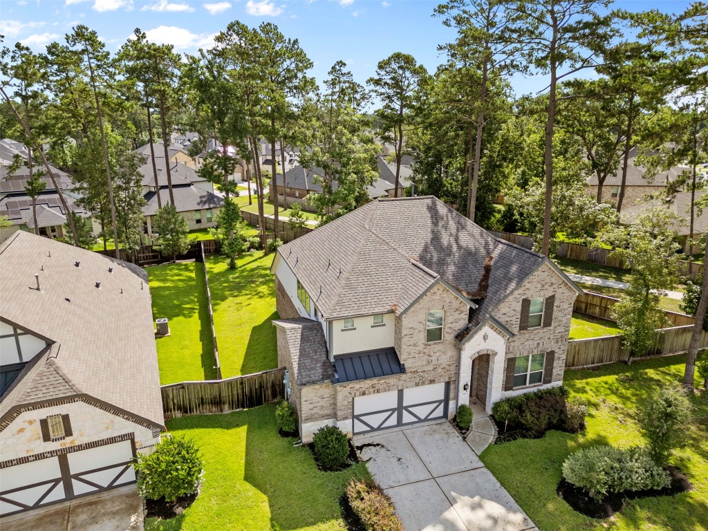 148 Gray Pne Grove Conroe, TX 77318 - Photo 3 of 46 an aerial view of a house with a yard patio and outdoor seating