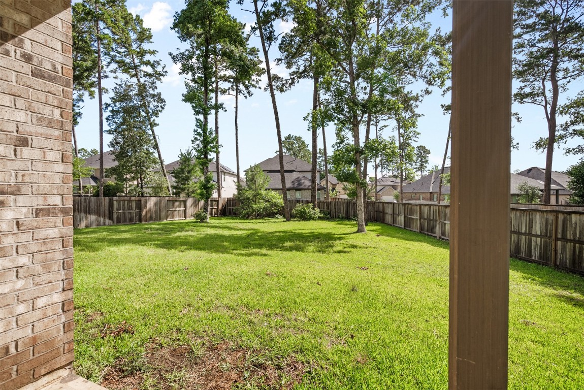 148 Gray Pne Grove Conroe, TX 77318 - Photo 37 of 46 a view of a yard in front of a house with a large tree