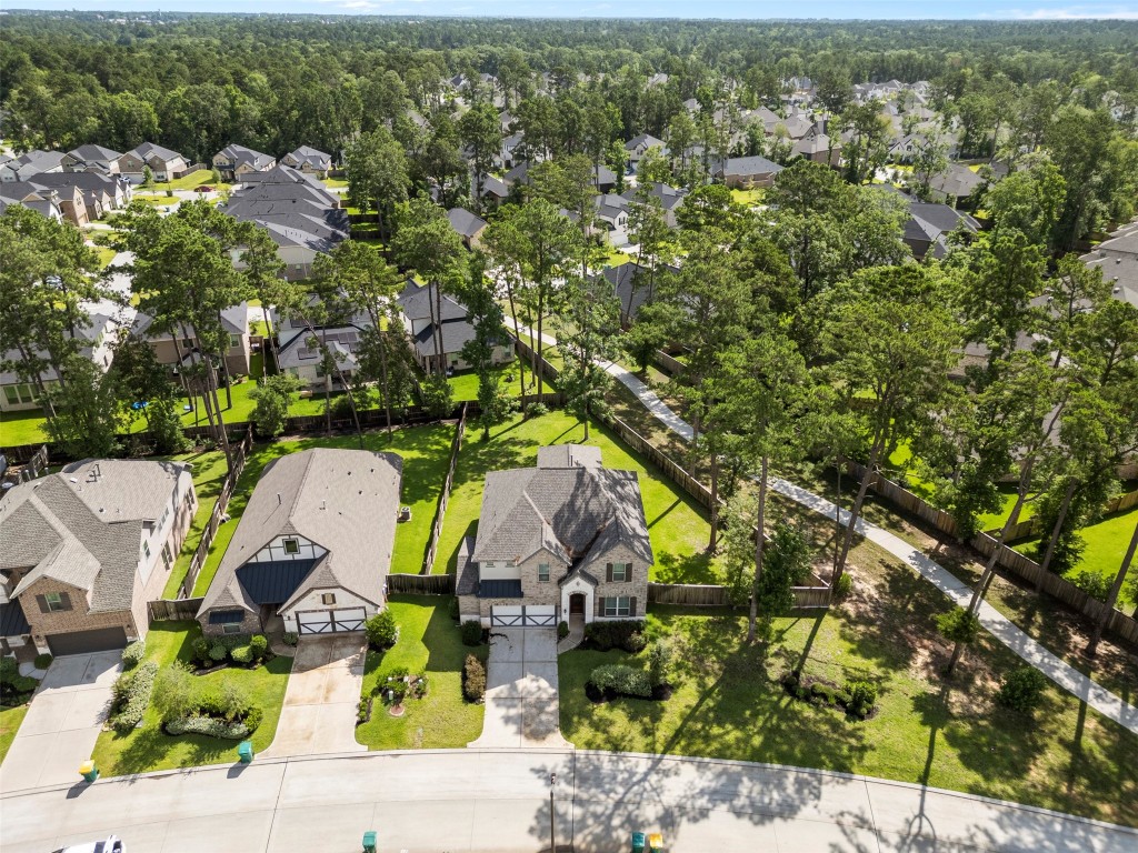 148 Gray Pne Grove Conroe, TX 77318 - Photo 4 of 46 an aerial view of a house with a yard and lake view