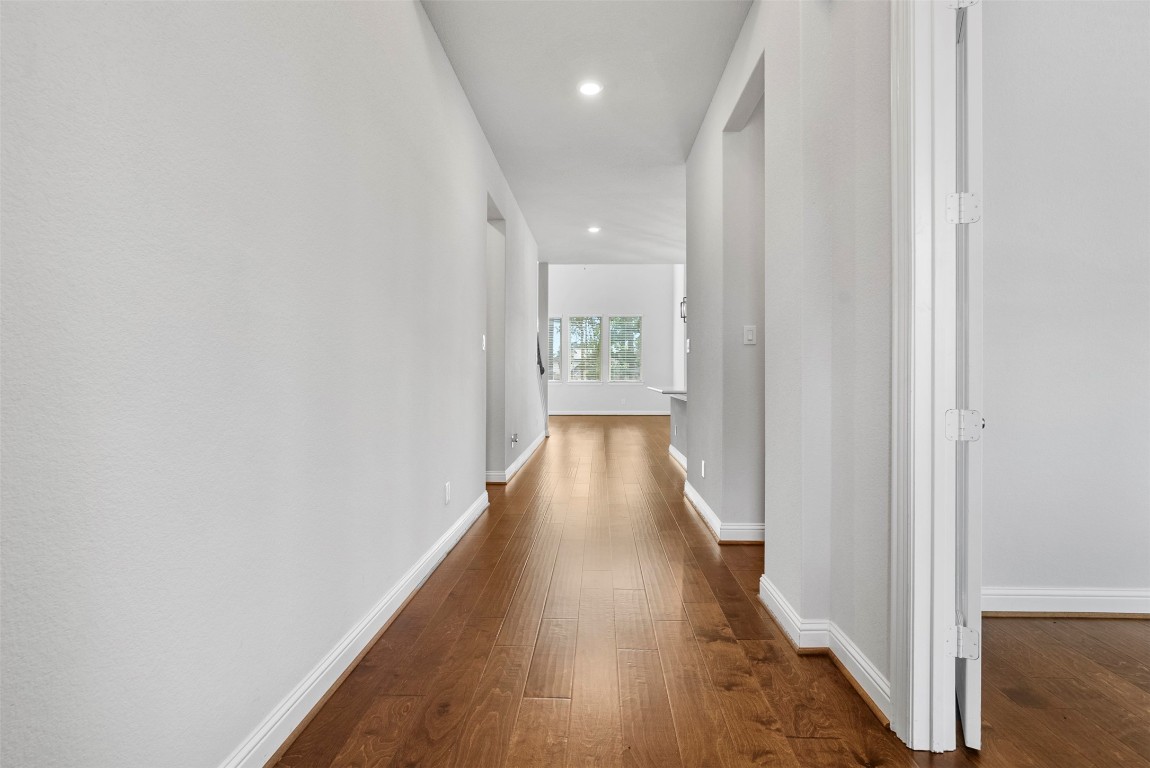 148 Gray Pne Grove Conroe, TX 77318 - Photo 9 of 46 a view of a hallway with wooden floor